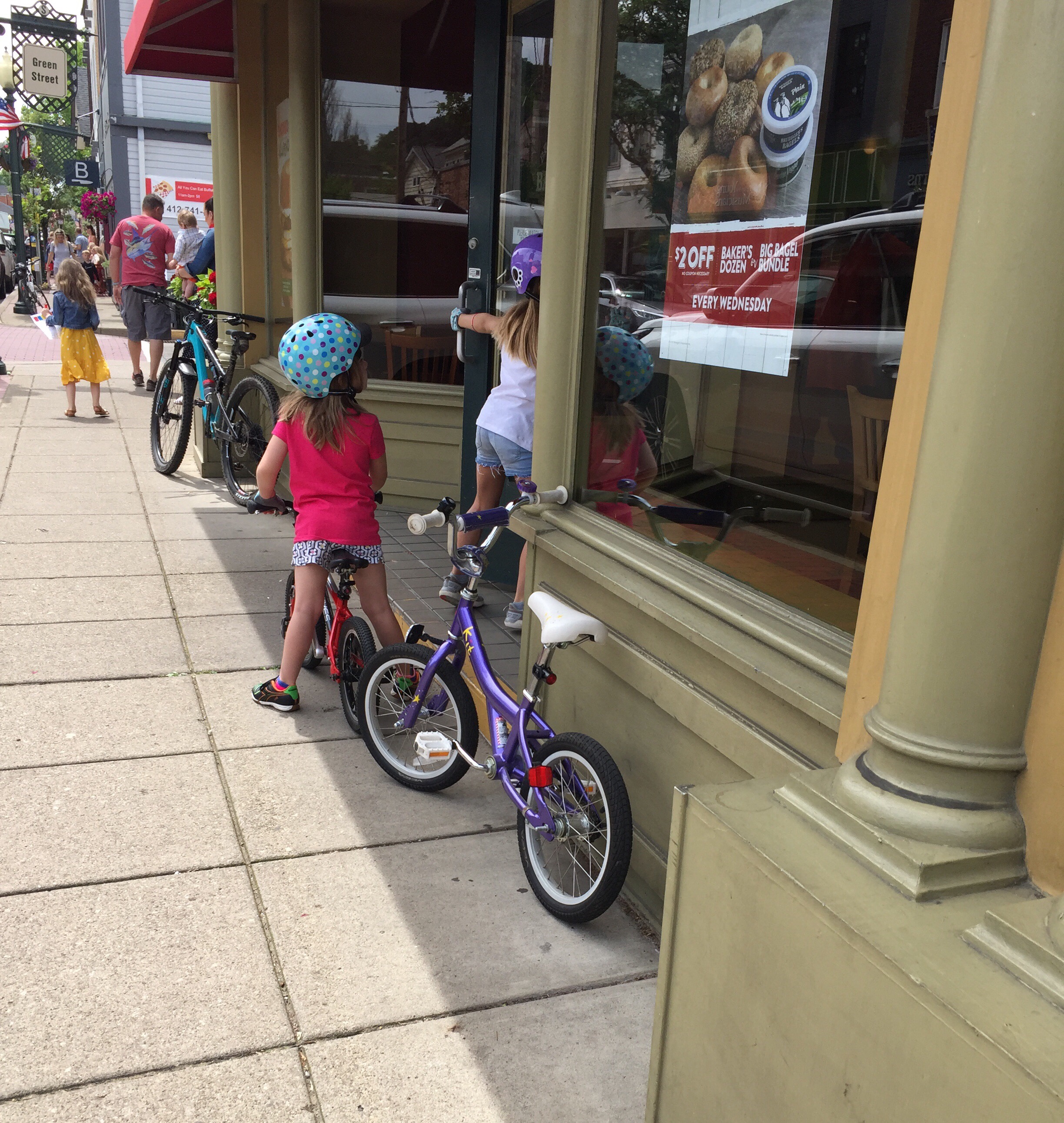 Kids riding bikes on sidewalk