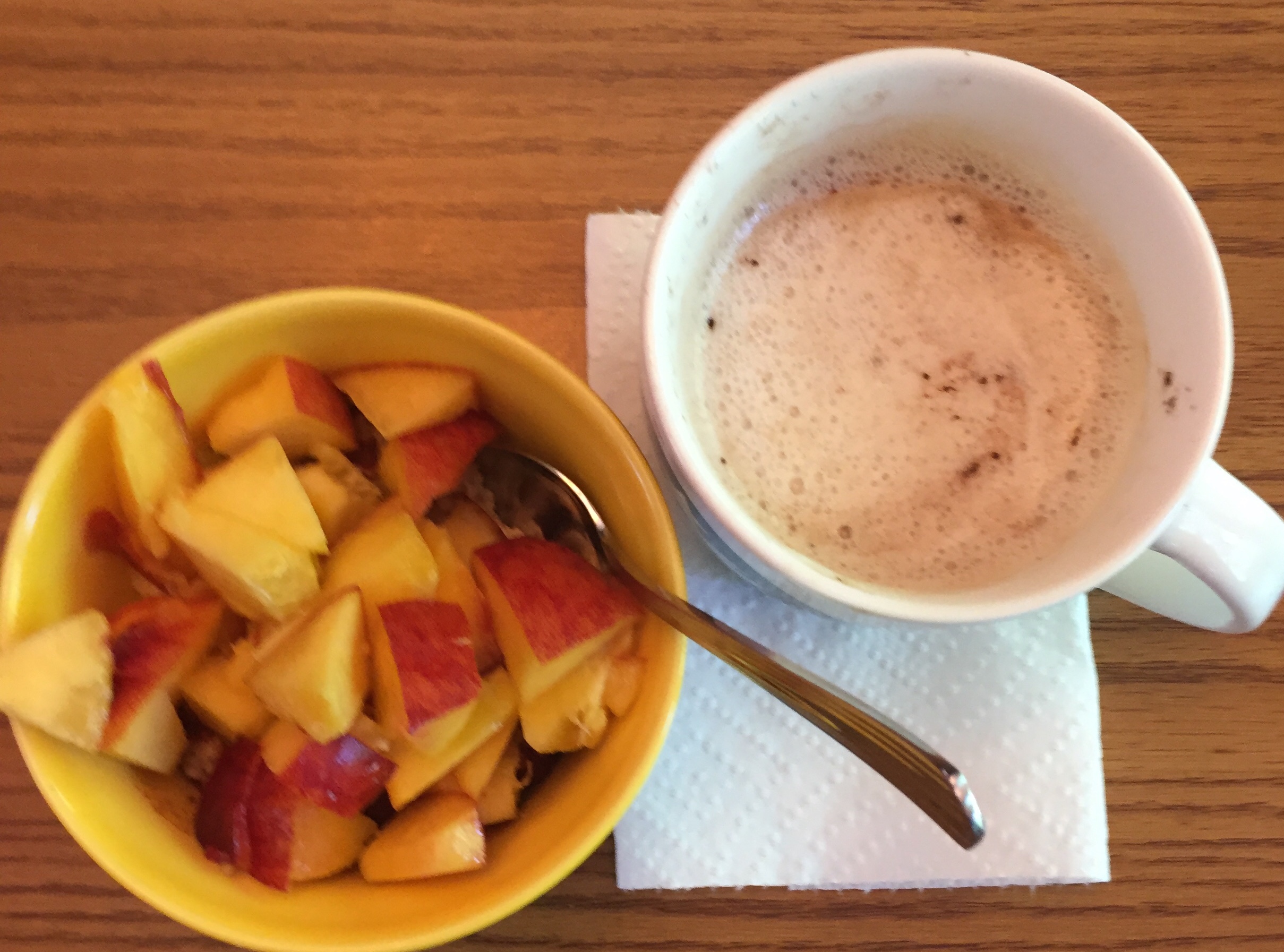 Bowl of oatmeal and cappuccino 
