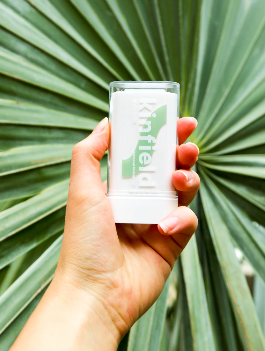 Hand holding vegan skincare product