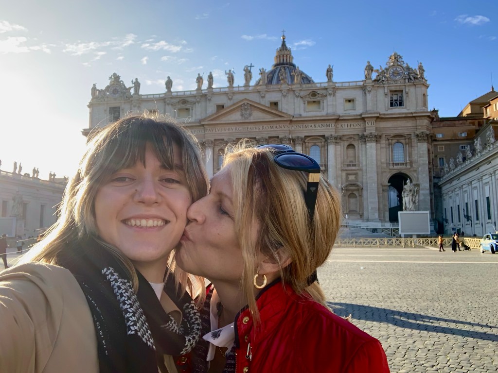 Photo of mother kissing daughter with the Vatican in the background